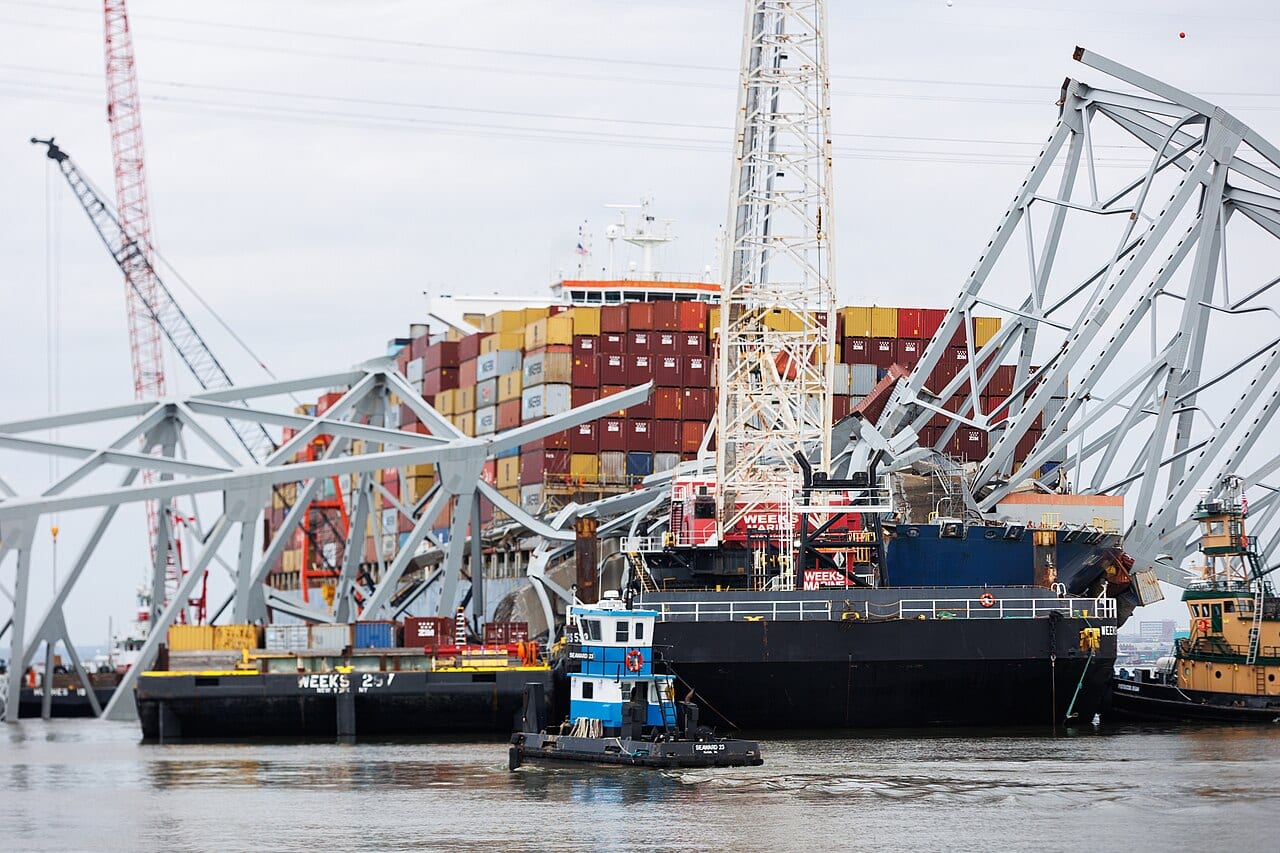 Salvage cranes lifting sections of the collapsed steel truss span away from the bow of the Dali during wreckage removal in April 2024.