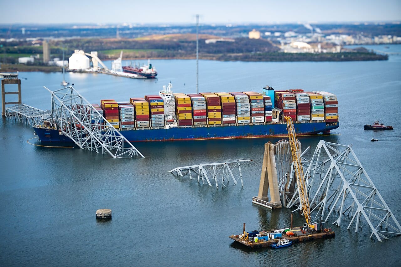 Aerial overflight photo of the collapsed Francis Scott Key Bridge wreckage in the water, taken during a Coast Guard helicopter damage assessment three days after the collapse.