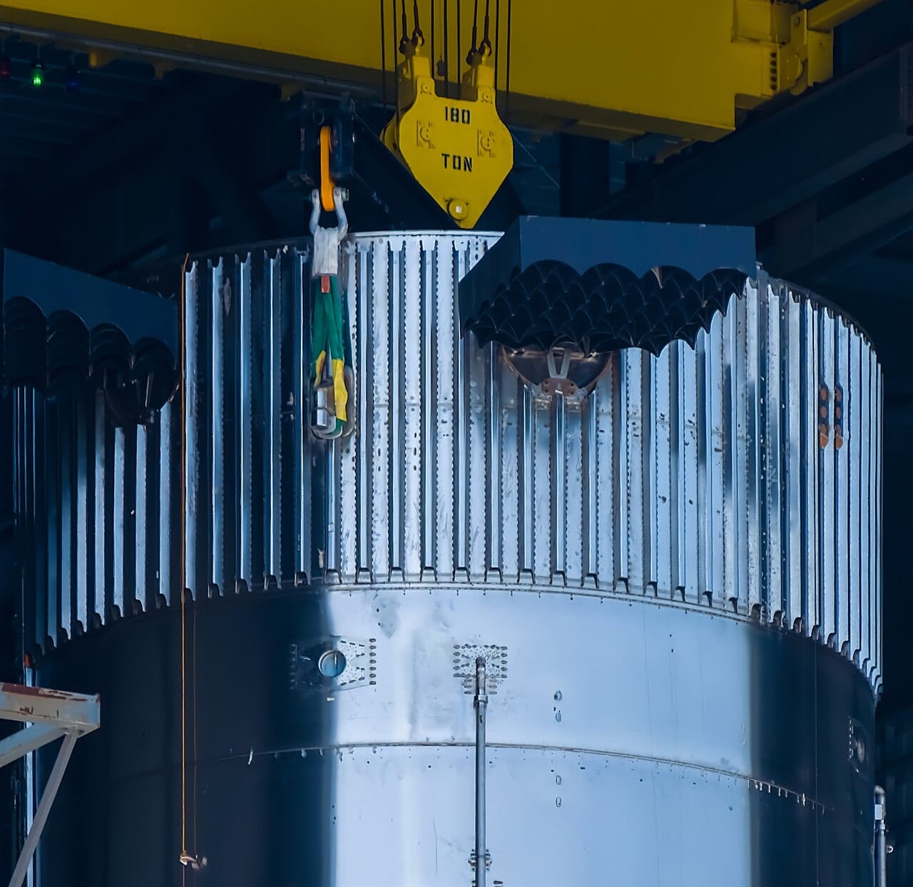 Close-up of the grid fins on a Super Heavy booster prototype inside Starbase’s High Bay assembly building.