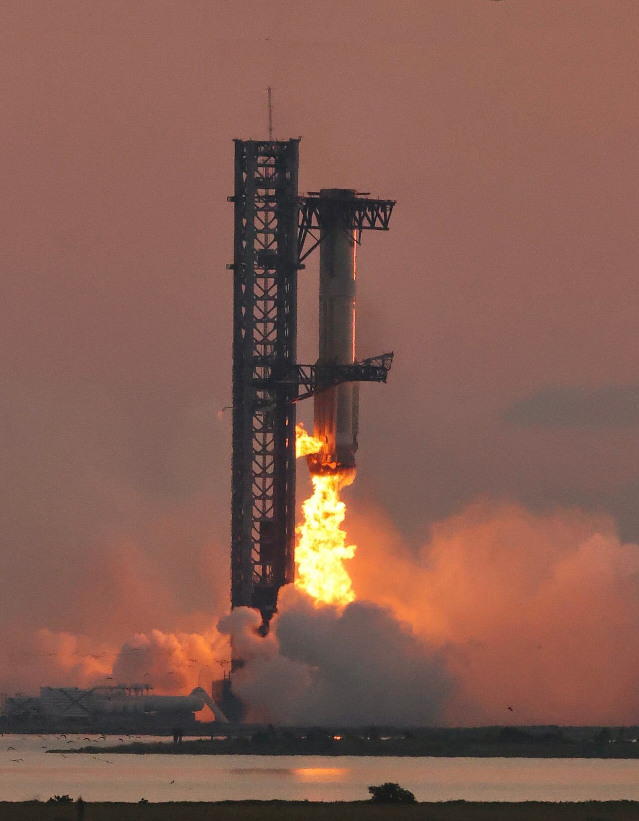 Super Heavy booster held inside the launch tower’s two mechanical arms moments after being caught during Flight 5.